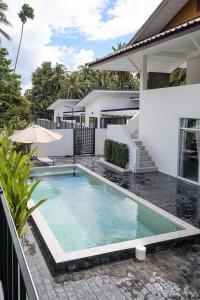 a swimming pool in front of a house at Coconut Breeze Villa 3 in Haad Chao Phao