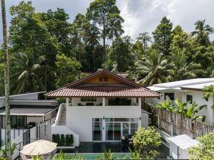 an image of a white house with trees in the background at Coconut Breeze Villa 3 in Haad Chao Phao
