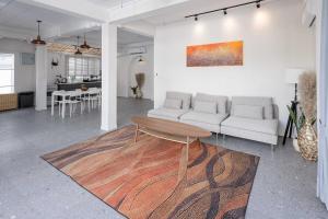 a living room with a couch and a table at Coconut Breeze Villa 3 in Haad Chao Phao