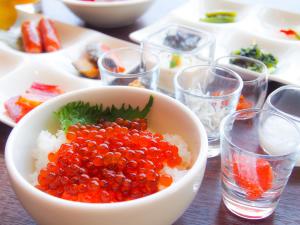 eine Schale Obst auf Reis und Gläser Wasser in der Unterkunft Hotel Emisia Sapporo in Sapporo
