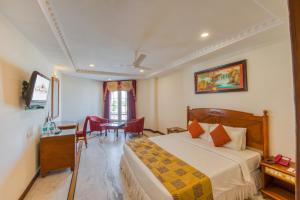 Ένα ή περισσότερα κρεβάτια σε δωμάτιο στο Hotel Le Royal Park - Puducherry
