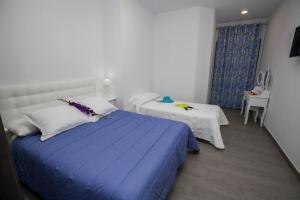 Posteľ alebo postele v izbe v ubytovaní Hostal Boutique Bajamar