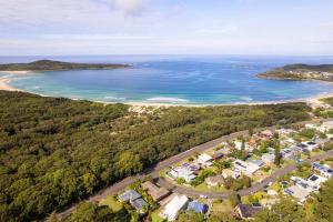 an aerial view of the beach and ocean at Magnolias, 6 Marine Dr - air con, linen and Wi-Fi in Fingal Bay