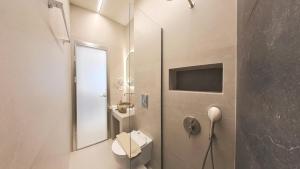 a bathroom with a toilet and a mirror at Hotel Galaxias in Paralia Katerinis +41 photos