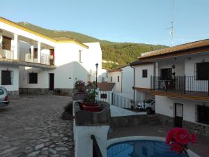 a courtyard with a house and a swimming pool at Casa Dominga in El Bosque