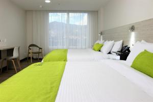 Postel nebo postele na pokoji v ubytování Arame Hotel