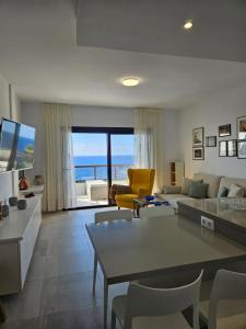 a living room with a view of the ocean at Apartment mit Poolsicht in Costa Del Silencio