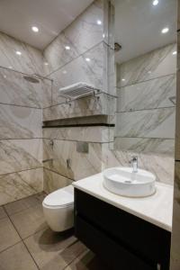 a bathroom with a sink and a toilet at Royal escape in Gurgaon