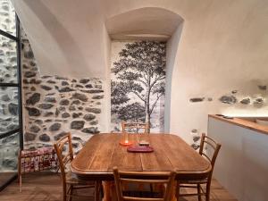 a dining room with a wooden table and chairs at Charming Studio Saint Martin Vésubie in Saint-Martin-Vésubie