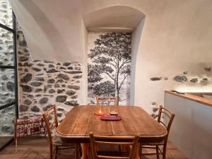 a dining room with a wooden table and chairs at Charming Studio Saint Martin Vésubie in Saint-Martin-Vésubie +20 photos