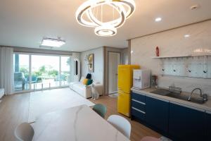 a kitchen with a sink and a counter top at Jeju Aneuk Stay in Seogwipo +7 photos