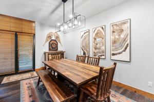 a dining room with a wooden table and chairs at Ski Tip 8709 by Summit County Mountain Retreats in Keystone