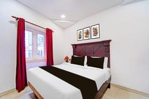 Ένα ή περισσότερα κρεβάτια σε δωμάτιο στο Hotel O Malabar Plaza