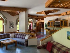 a living room with a couch and a table at Hotel Lizumerhof in Axamer Lizum