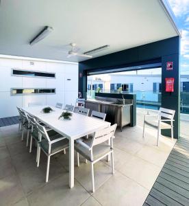 WindangResort on Cedar的厨房和餐厅配有白色桌子和椅子