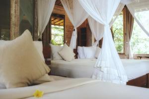 Postel nebo postele na pokoji v ubytování Naya Ubud
