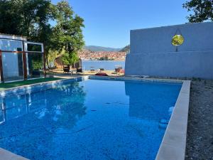 a swimming pool in front of a house with the water at CHALET Orsova in Orşova