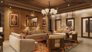 a living room with couches and a chandelier at Taj Paro Resort & Spa in Paro