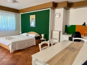 a bedroom with a bed and a green wall at Fine & Shine in Pula