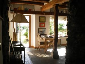 a dining room with a table and chairs in a room at Larraenea Bed and Breakfast in Lesaka