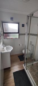 a bathroom with a sink and a toilet and a window at Sandpiper 7 - Cozy Oasis in Jeffreys Bay +19 photos