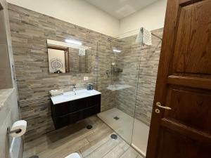a bathroom with a sink and a glass shower at INFORMIS B&B in Capua +65 photos