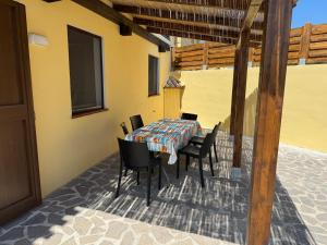 a table and chairs on the patio of a house at Residence del Golf in Cuile Pazzoni