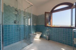 a bathroom with a toilet and a glass shower at Residence del Golf in Cuile Pazzoni +52 photos