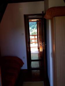 a hallway with an open door to a room at Viola i Detelina Apartments in Perućac