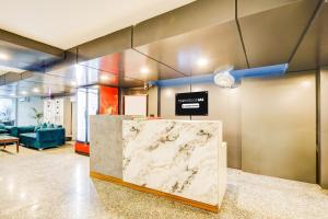 Posezení v ubytování Super Townhouse Oak Udyog Vihar