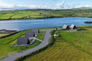 an aerial view of a river with a boat in the water at Wild Atlantic Pods in Portmagee