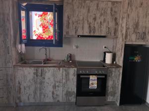 A kitchen or kitchenette at Iliovasilema VILLAGE