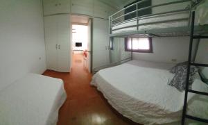 a bedroom with two bunk beds and a hallway at GirasolesV in Sanlúcar de Barrameda +20 photos
