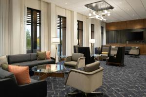 a lobby with couches and chairs and a table at Courtyard by Marriott Billings in Billings