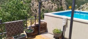 a balcony with a swimming pool and potted plants at Casa Jerónimo in Loporzano