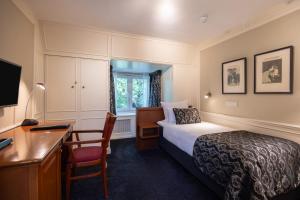a hotel room with a bed and a desk and a computer at Apollofirst Boutique Hotel in Amsterdam +28 photos