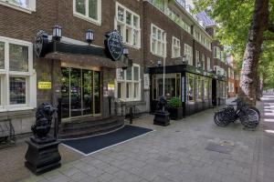 a building on a street with bikes parked outside of it at Apollofirst Boutique Hotel in Amsterdam