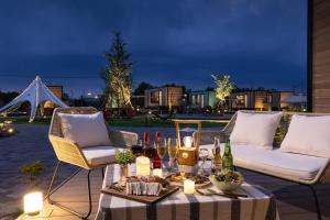 a table with wine bottles and candles on a patio at Lectore Hanyu Terrace - TKP Hotels & Resorts in Hanyu