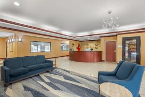 a lobby with two blue couches and a waiting room at Comfort Suites South Bend Near Casino in South Bend +58 photos
