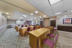 a conference room with tables and chairs and a podium at Comfort Suites Ontario Airport Convention Center in Ontario +40 photos