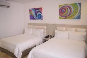 Postel nebo postele na pokoji v ubytování Radisson Diamond Barranquilla