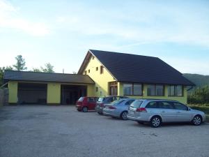 a group of cars parked in front of a house at House Mara in Korenica