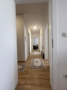 an empty hallway with two rugs on the floor at 3 bedroom Family apartment in Vushtrri in Mitrovicë +1 photo