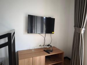 a flat screen tv sitting on top of a wooden table at Villa Royal Arois Unit C-01 in Batu