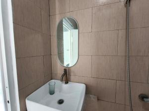 a bathroom with a sink and a mirror at Villa Royal Arois Unit C-01 in Batu +8 photos