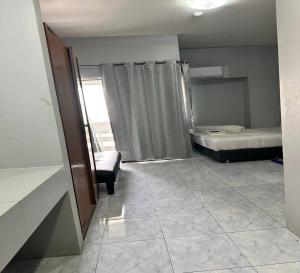 a room with two beds and a couch and a window at ATVR Juldis Tower Pratunam in Bangkok +18 photos