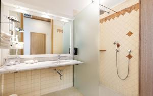 a bathroom with a sink and a shower at Kim Schlosshotel im Park in Dresden +20 photos