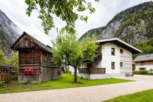 a house in front of a mountain at W & S Executive Apartments - Hallstatt I in Hallstatt