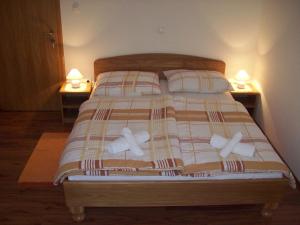 a bedroom with a bed with two pillows on it at House Mara in Korenica