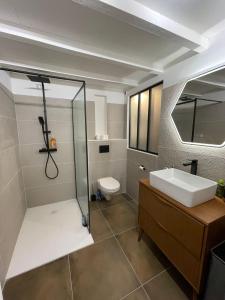 a bathroom with a shower and a sink and a toilet at Nid douillet - maison Spinola in Bastia